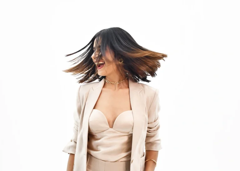 Model with sleek dark bob haircut wearing beige blazer, styled by Bellance Salon