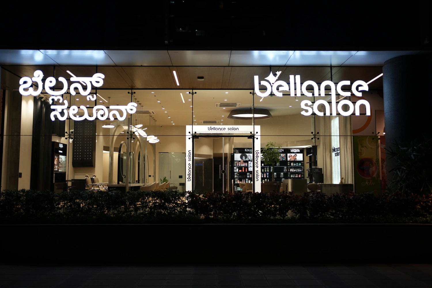 Bellance Salon Bangalore glowing storefront at night with bilingual signage