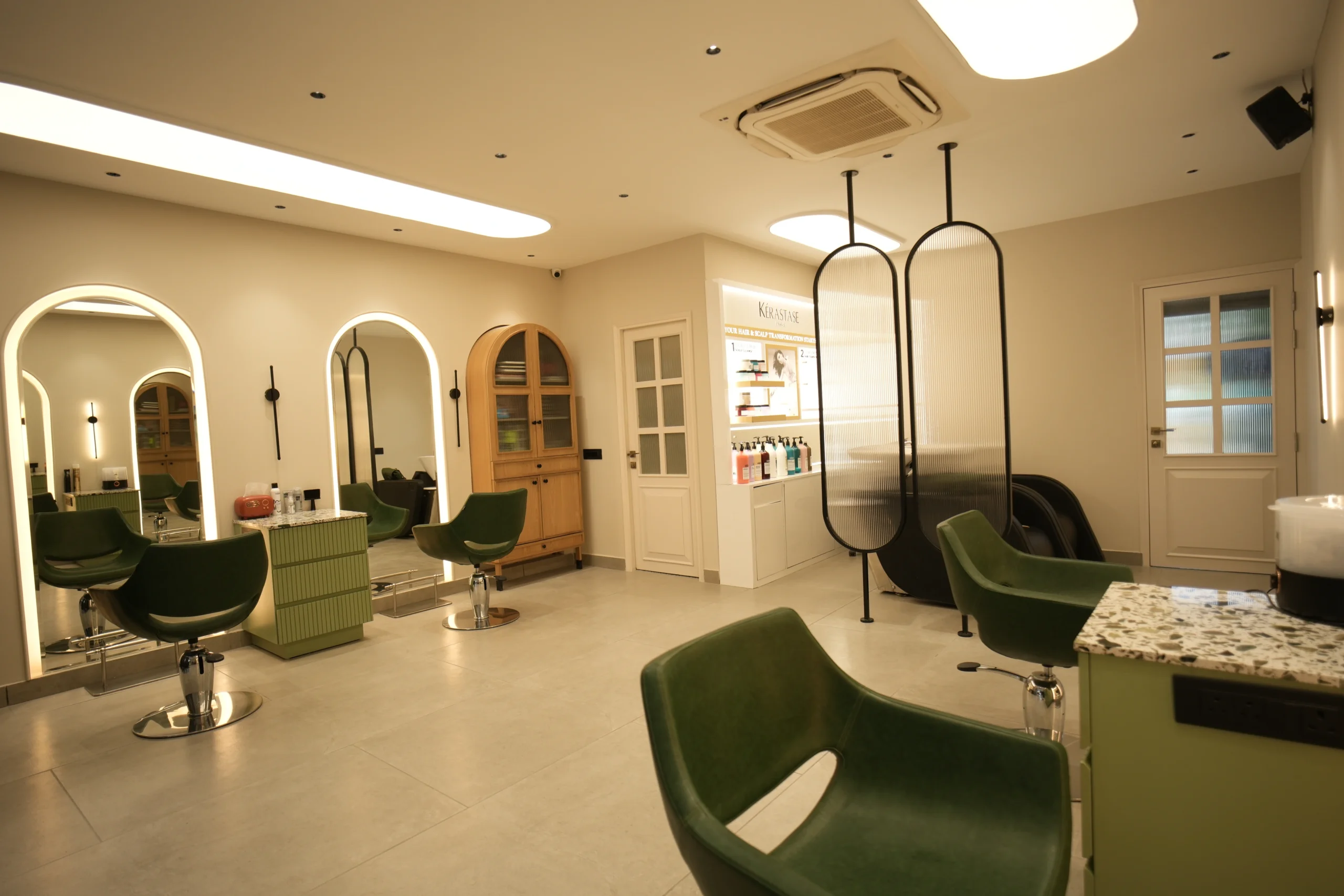 Bellance Salon women's floor showing styling stations, arched mirrors, Kérastase display, and decorative oval partitions